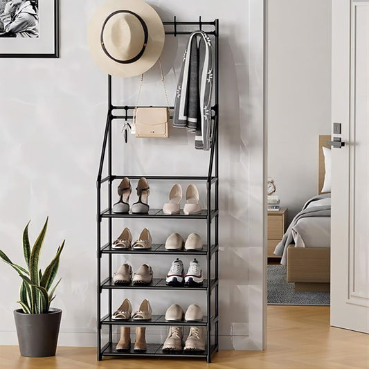 Black shoe rack with shoes, a hat, and a bag against a white wall.
