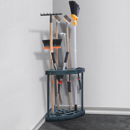 Corner tool rack holding various gardening tools against a white wall.